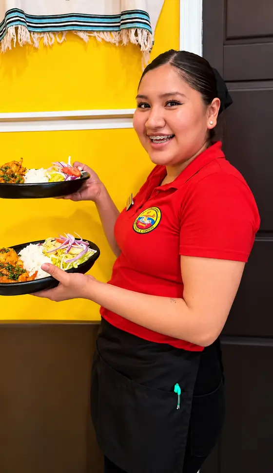 Server carrying two shrimp and rice plates at El Rinconcito Paisa 2, Hollis Queens