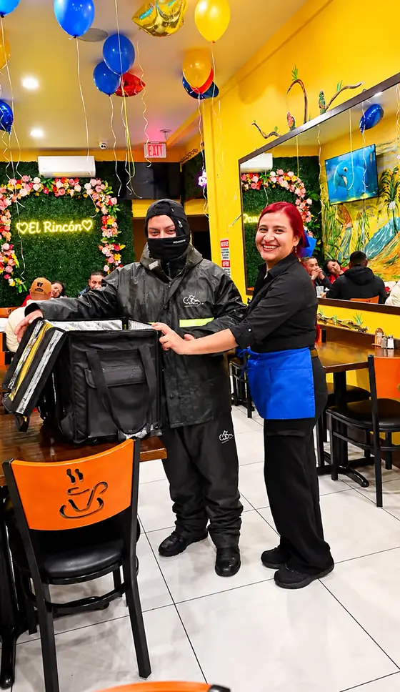 Delivery driver picking up an order at El Rinconcito Paisa 2, Hollis Queens