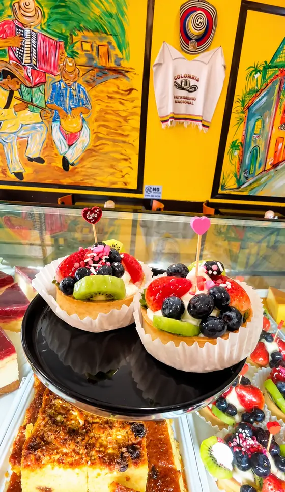 Colombian bakery display case with fruit tarts and desserts at El Rinconcito Paisa 2